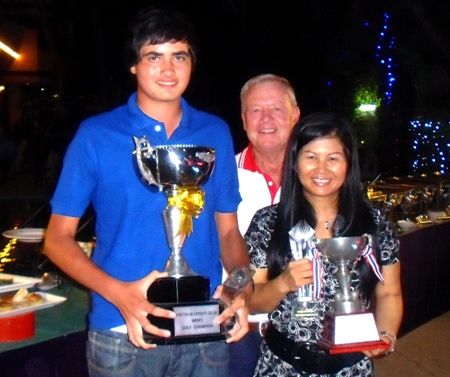 Men’s and Ladies Annual Club Champions, Patrick Kelly, left, and Ngamjit Emmerson, right, hold their trophies while the PSC Golf Chairman Joe Mooneyham stands center rear.
